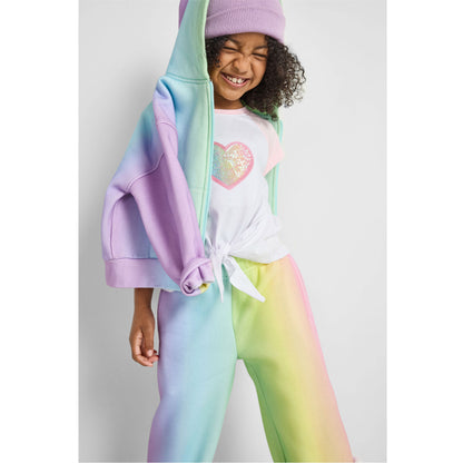 girl wearing our sustainable rainbow wide-leg jogger set and heart knotted baseball tee