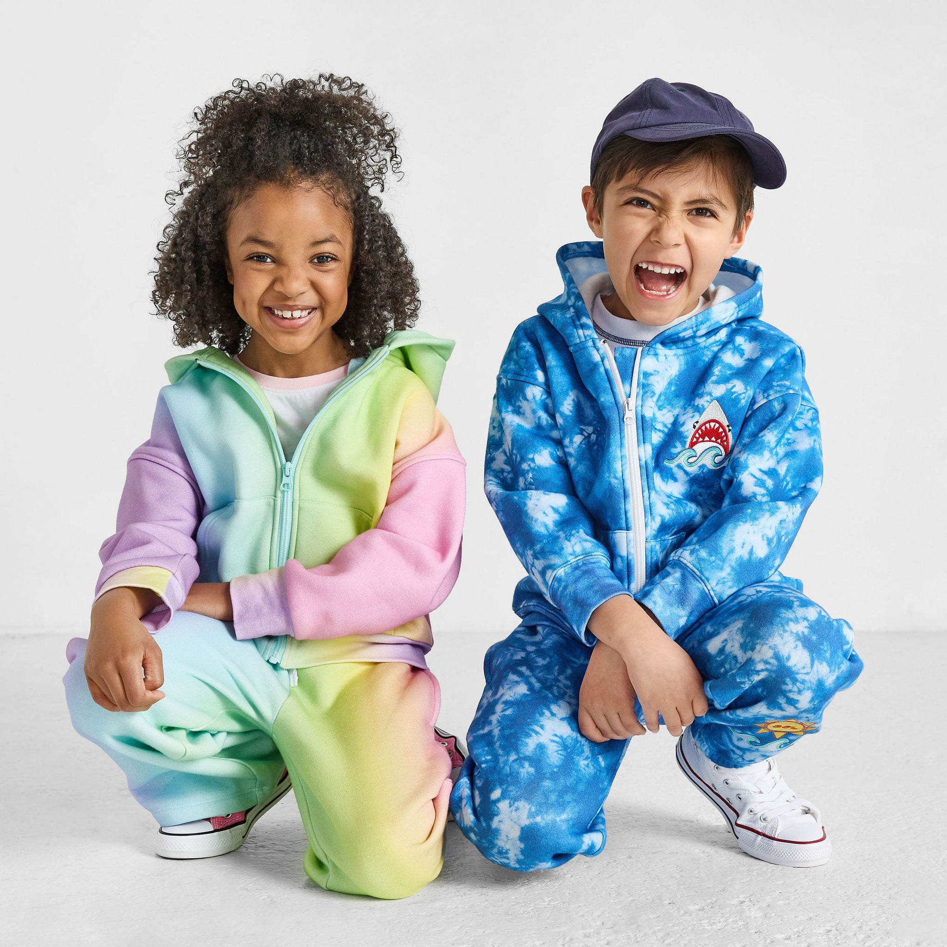 girl wearing our sustainable rainbow wide-leg jogger set and boy wearing our shark tie-dye jogger set
