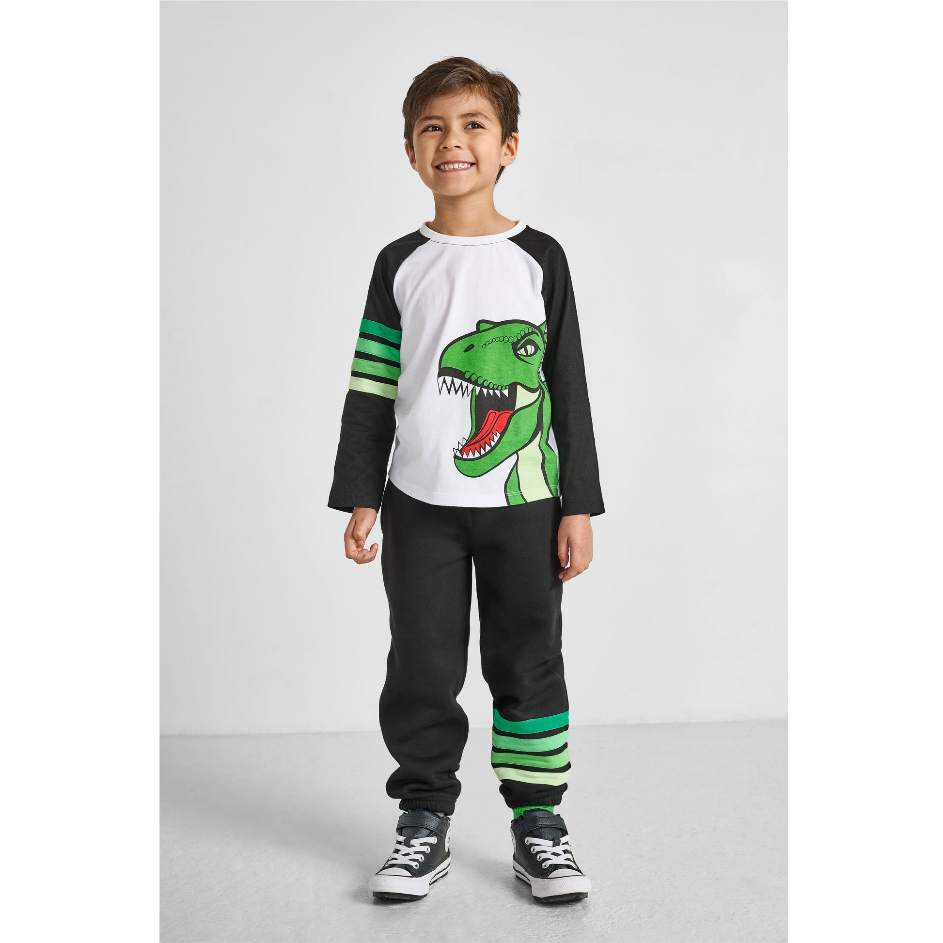 boy wearing our eco-friendly dinosaur baseball tee with green striped joggers