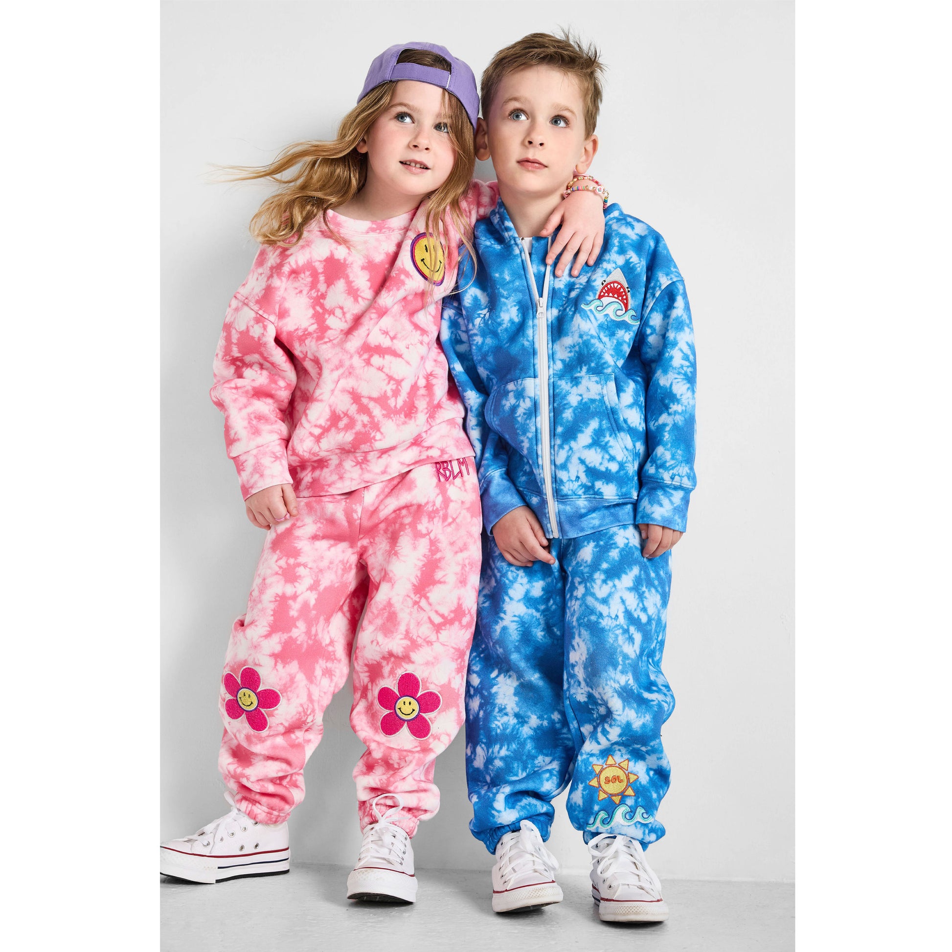 Girl wearing our sustainable Smiley Tie-Dye Set and boy wearing our Shark Tie-Dye Set