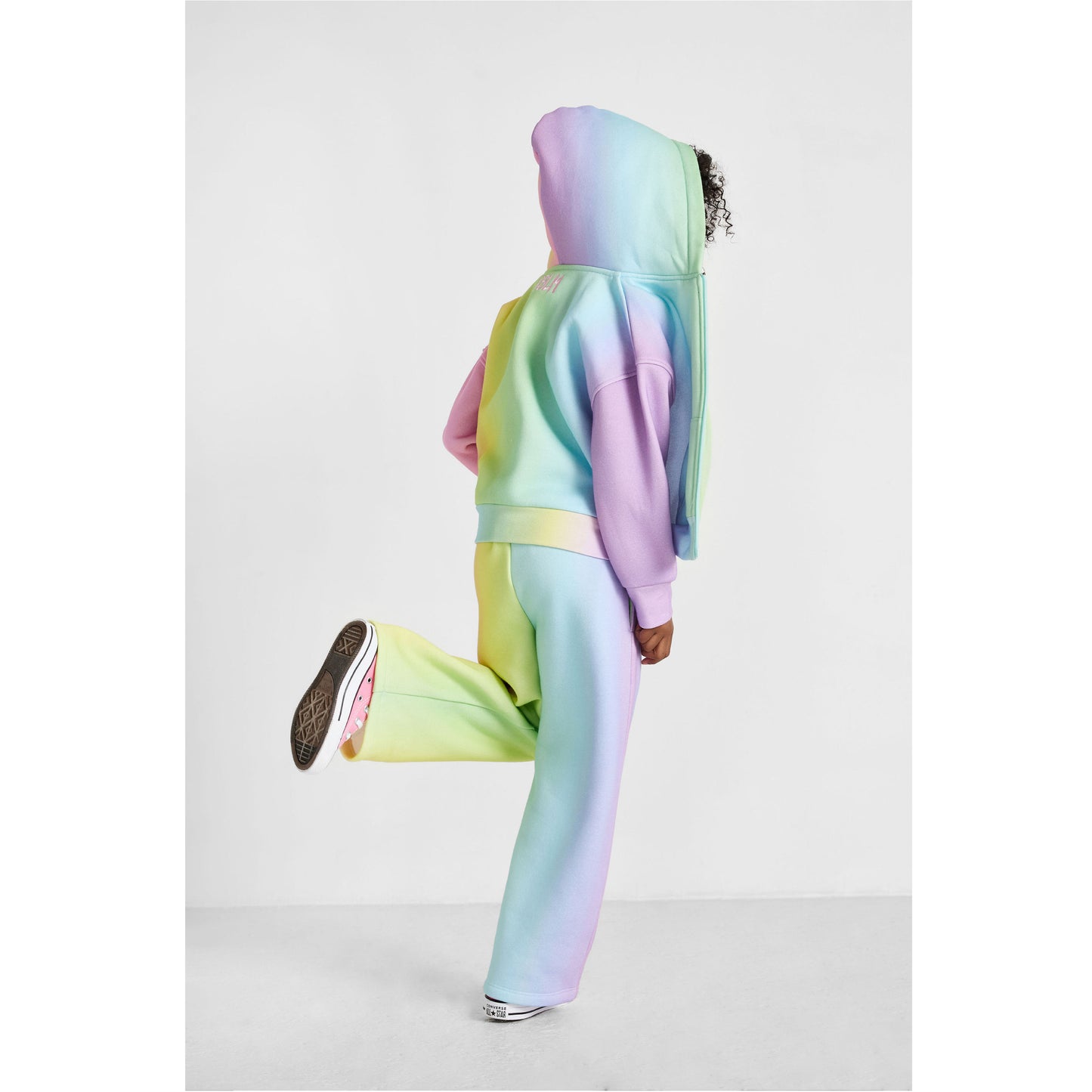 girl wearing our sustainable rainbow wide-leg jogger set, showing back of outfit