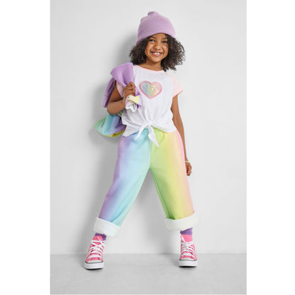 girl wearing our sustainable heart knotted baseball tee with rainbow wide-leg joggers