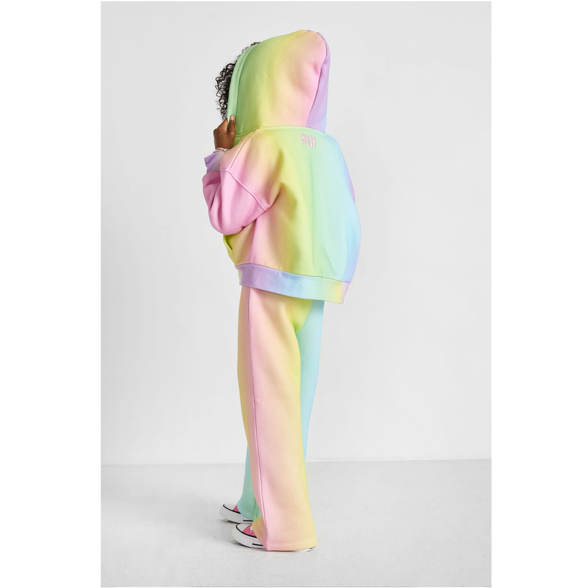 girl wearing our sustainable rainbow wide-leg jogger set, showing back of outfit