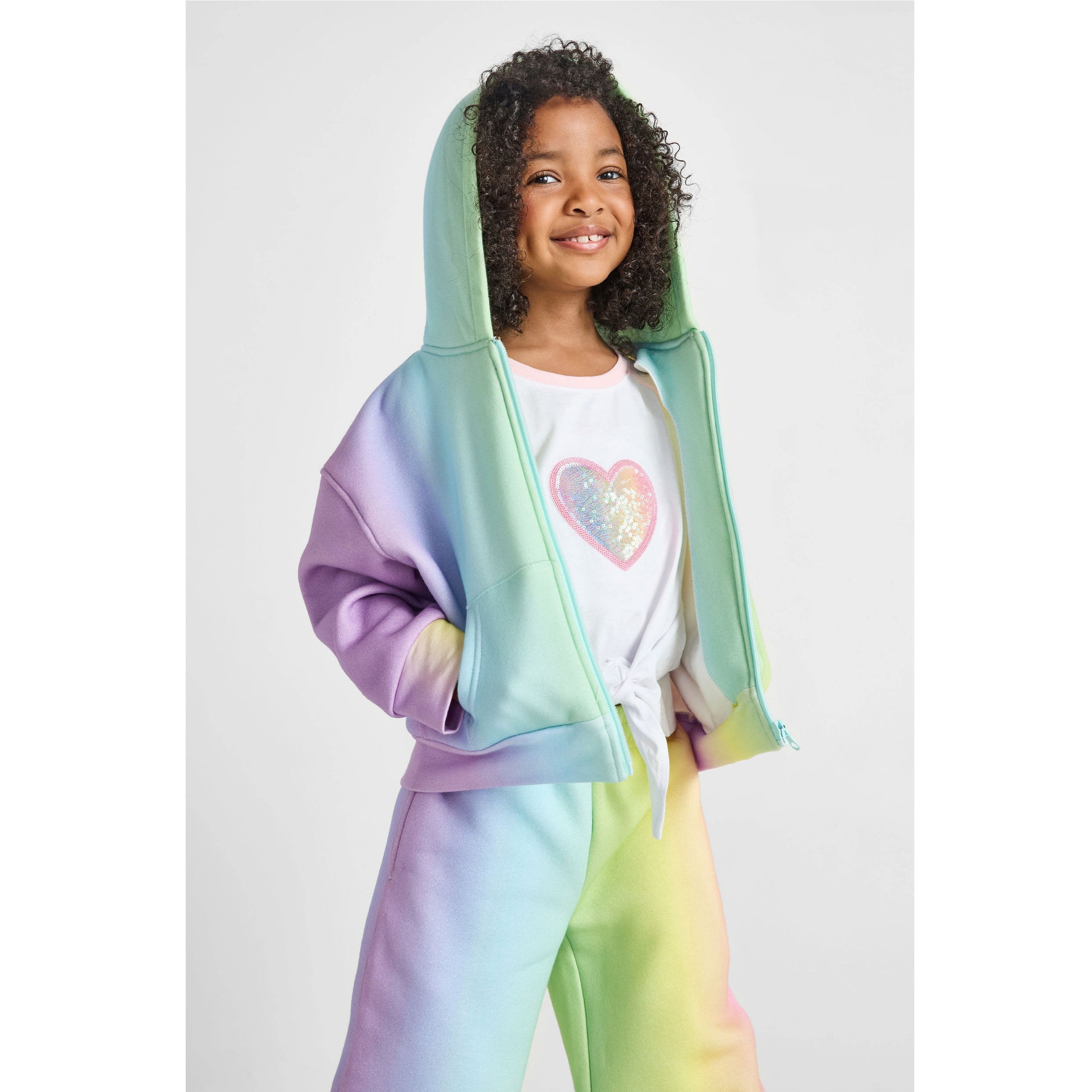 girl wearing our sustainable heart knotted baseball tee with rainbow wide-leg jogger set