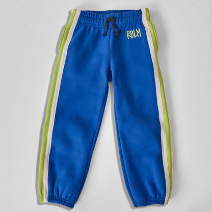 Sustainable and comfortable bright blue jogger sweatpants for kids with lime green and white side stripes, featuring a black and blue drawstring and 'RBLM' printed in green on the left hip, shown flat on a light gray background.