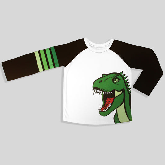 A sustainable and comfortable long-sleeve raglan baseball-style shirt with a white body, black sleeves, three green stripes on one sleeve, and a large green dinosaur graphic on the front, shown on a light gray background.