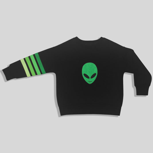 A sustainable, fun, and comfortable black long-sleeve sweatshirt for children, featuring a cute green alien head graphic on the center chest and four green stripes on one sleeve, displayed against a light gray background.