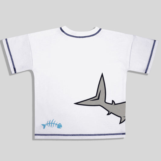 A sustainable and comfortable white short-sleeve t-shirt for kids with dark blue stitching on the collar and sleeve cuffs, featuring a gray cartoon shark tail and a light blue fish skeleton graphic on the back, shown against a solid gray background.
