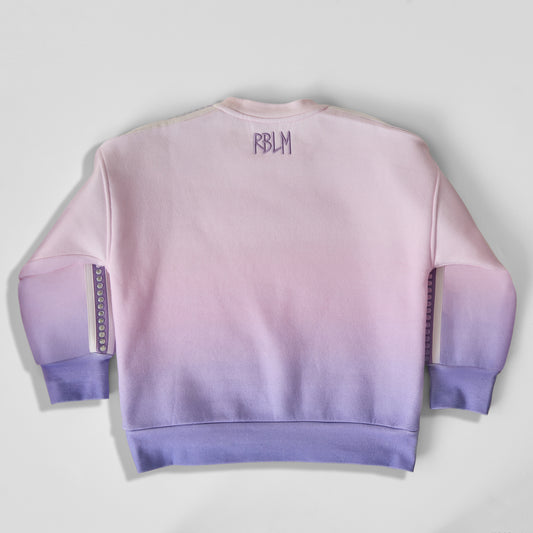 The back of an eco-friendly and comfortable light pink-to-purple gradient crewneck sweatshirt for children, featuring a purple 'RBLM' logo on the upper back.