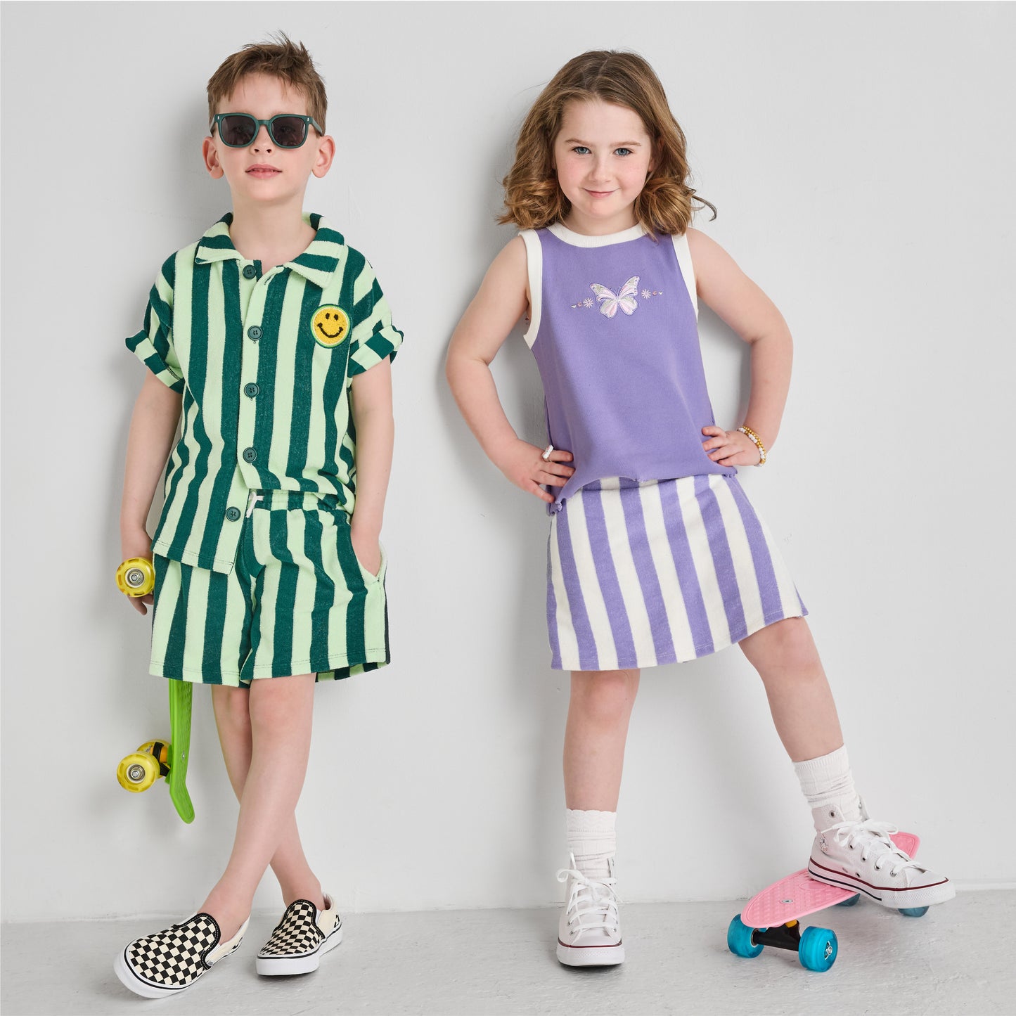 Boy and girl in colorful, sustainable striped outfits 