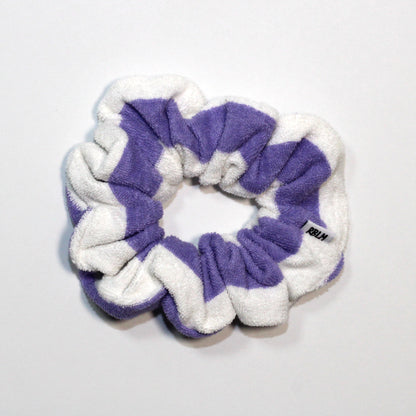 Purple and white scrunchie on a light gray background