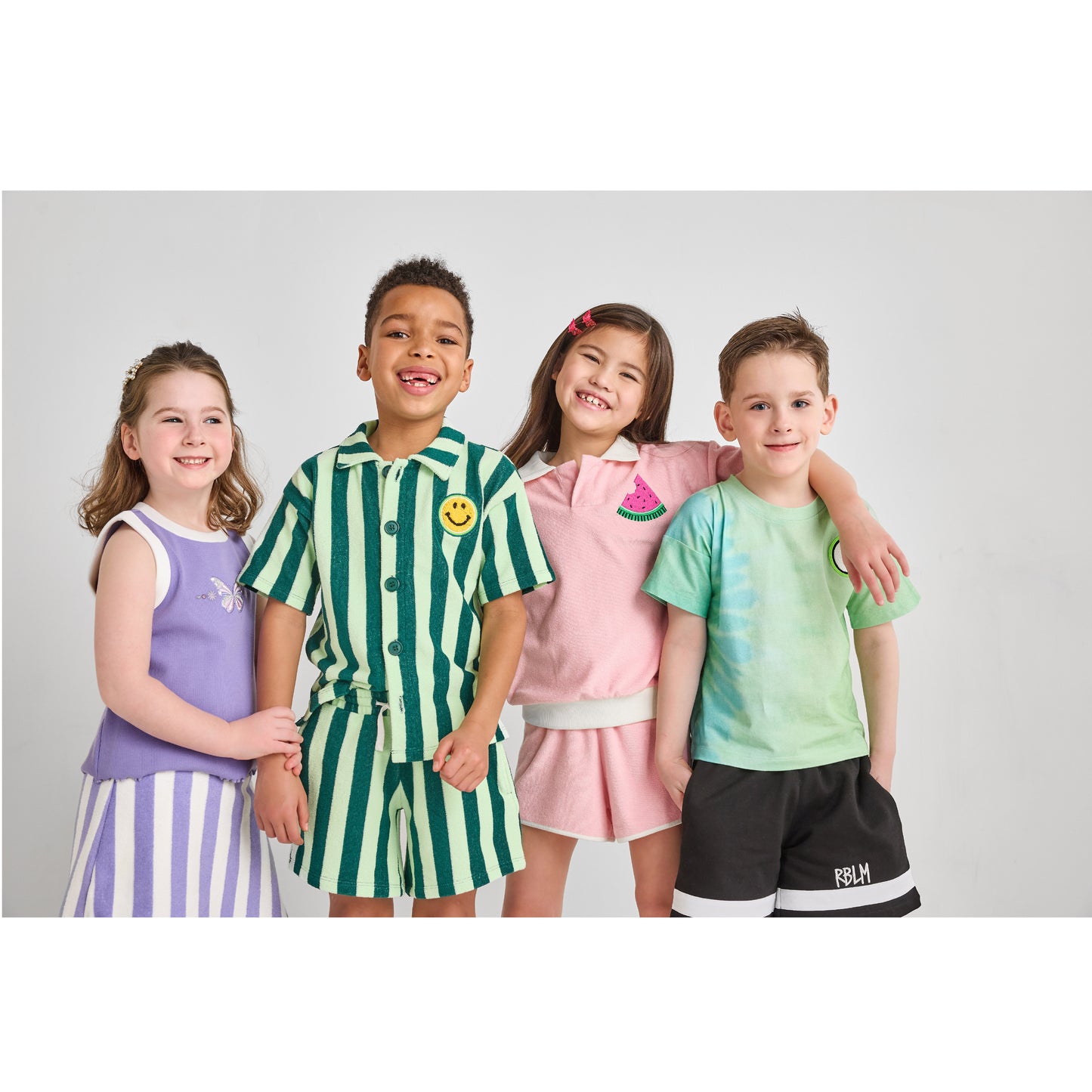 Four children wearing sustainable, hip, and colorful outfits.