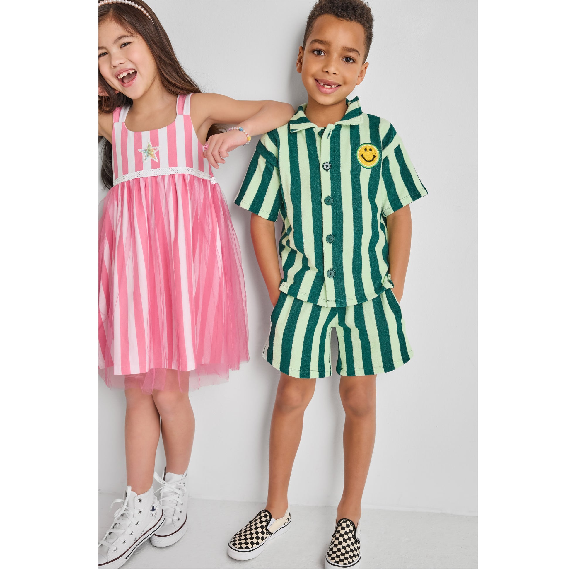 Girl and a boy wearing colorful, fun, sustainable outfits
