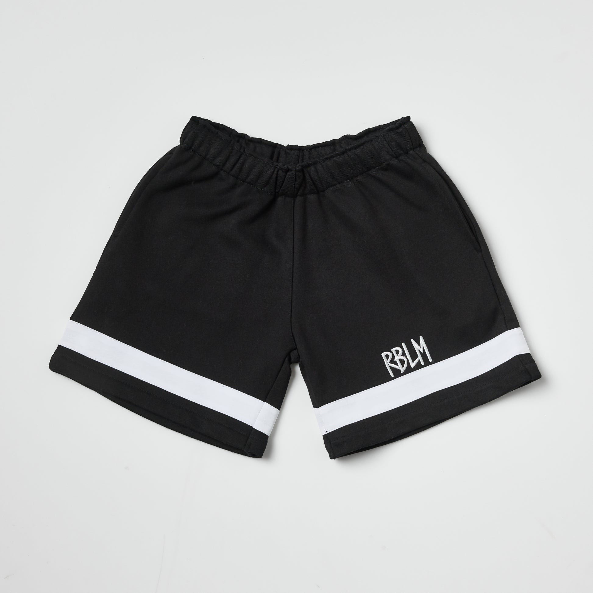Eco-friendly kids black shorts with a white stripe on a white background