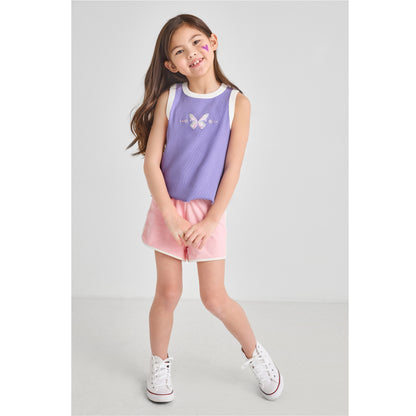 Young girl wearing a sustainable purple butterfly tank top and retro pink Terry shorts