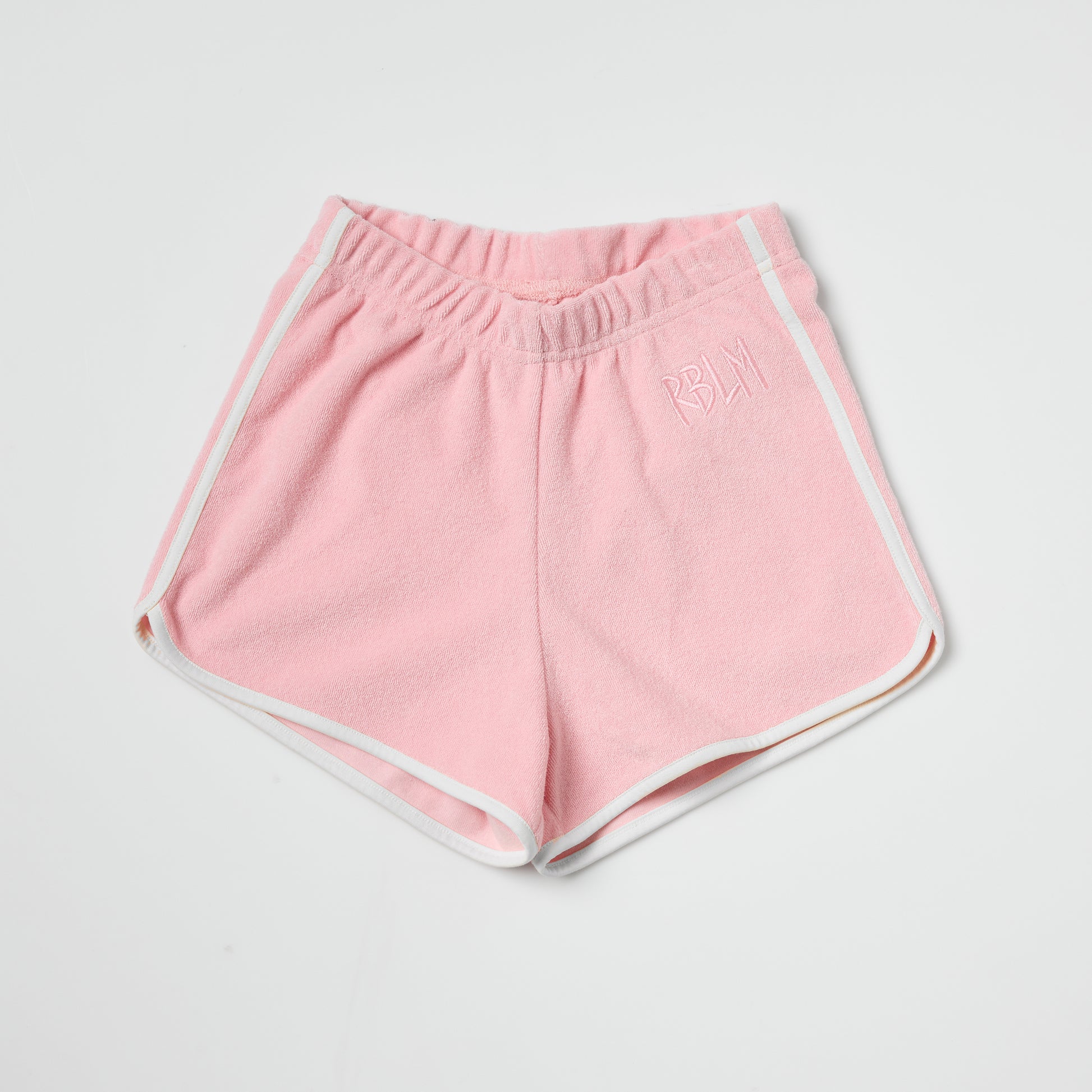 Eco-friendly kids pink shorts with white trim on a light gray background