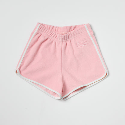 Eco-friendly kids pink shorts with white trim on a light gray background