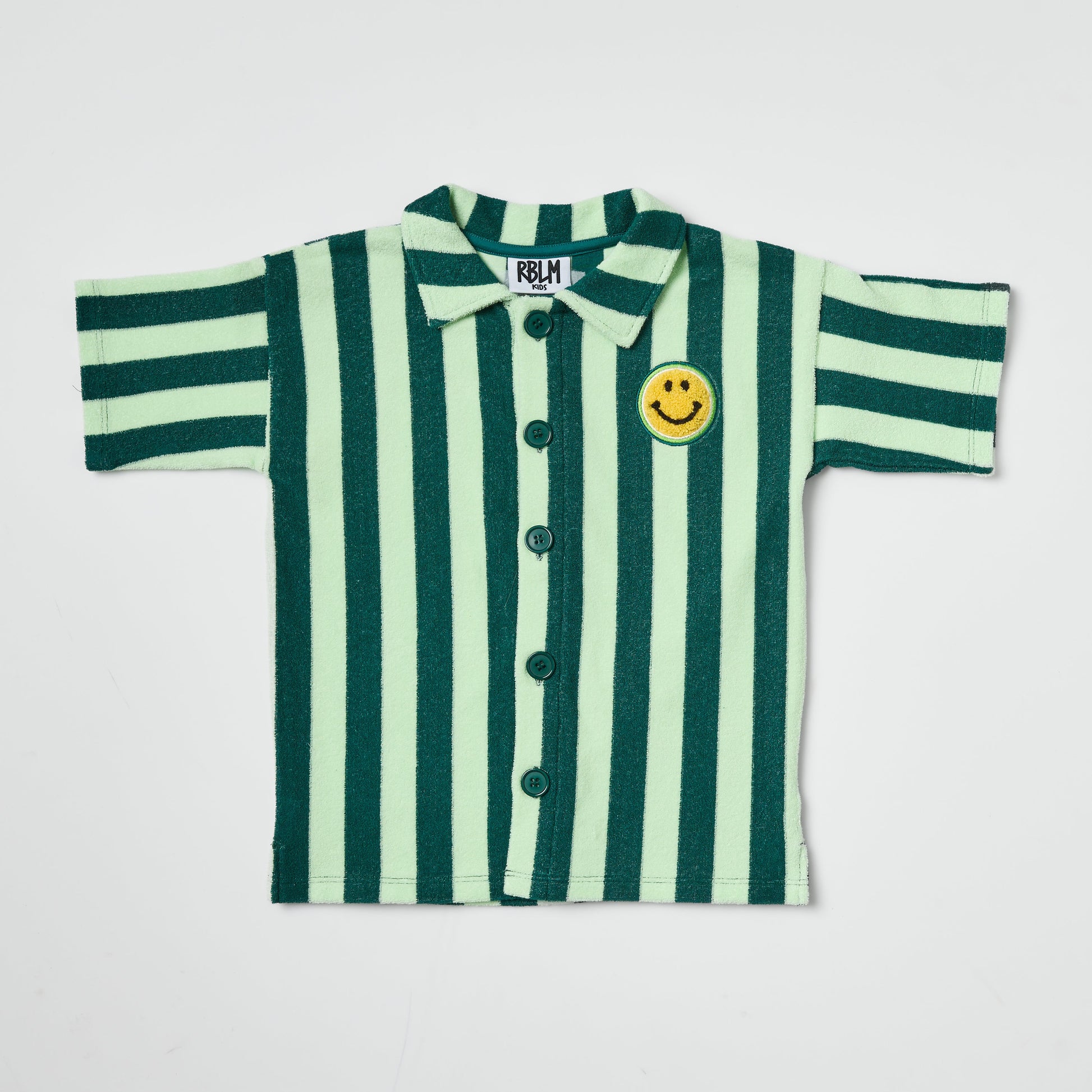 Eco-friendly kids green-striped shirt with a smiley face patch on a light gray background