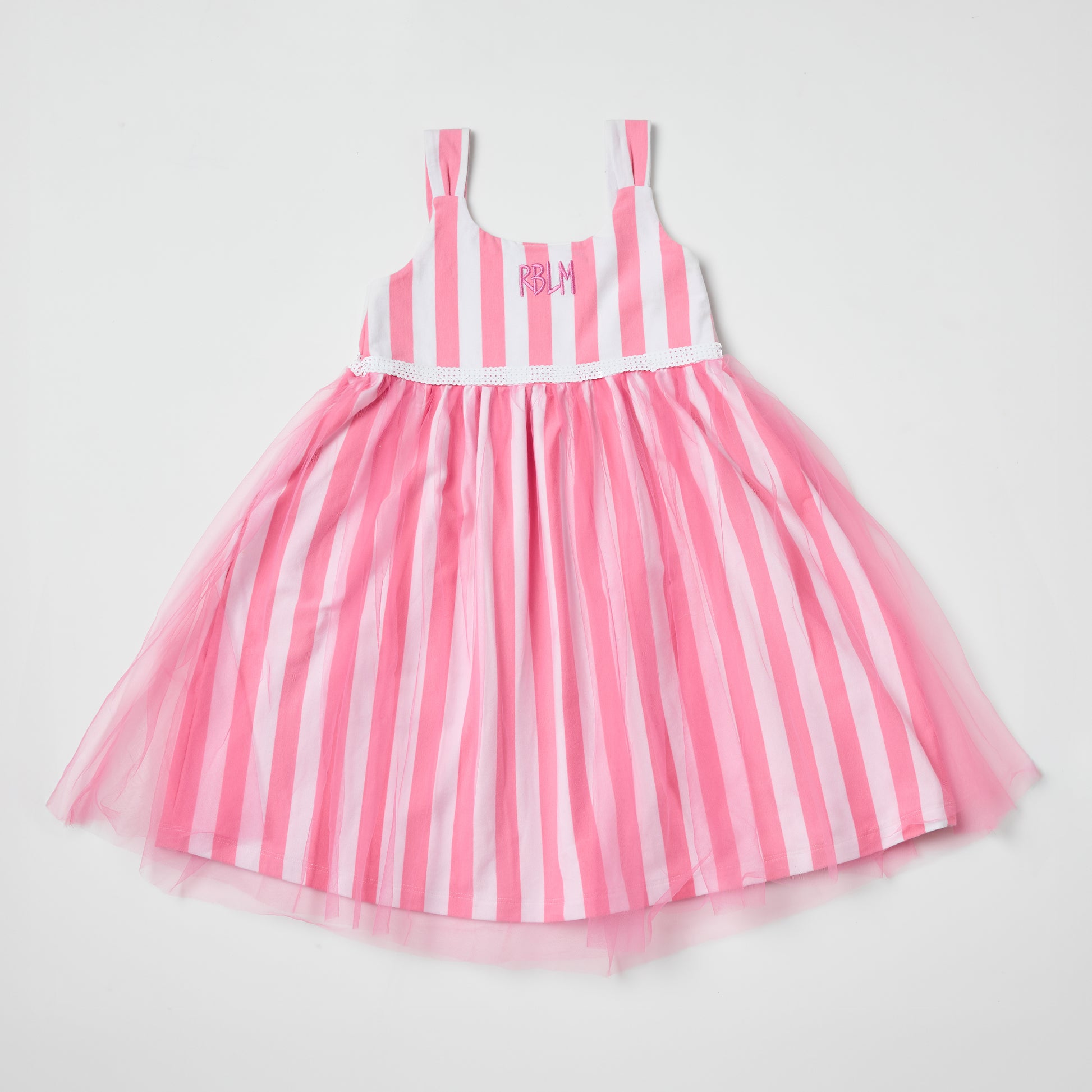 Sustainable kids pink and white striped dress with a tulle skirt on a light gray background