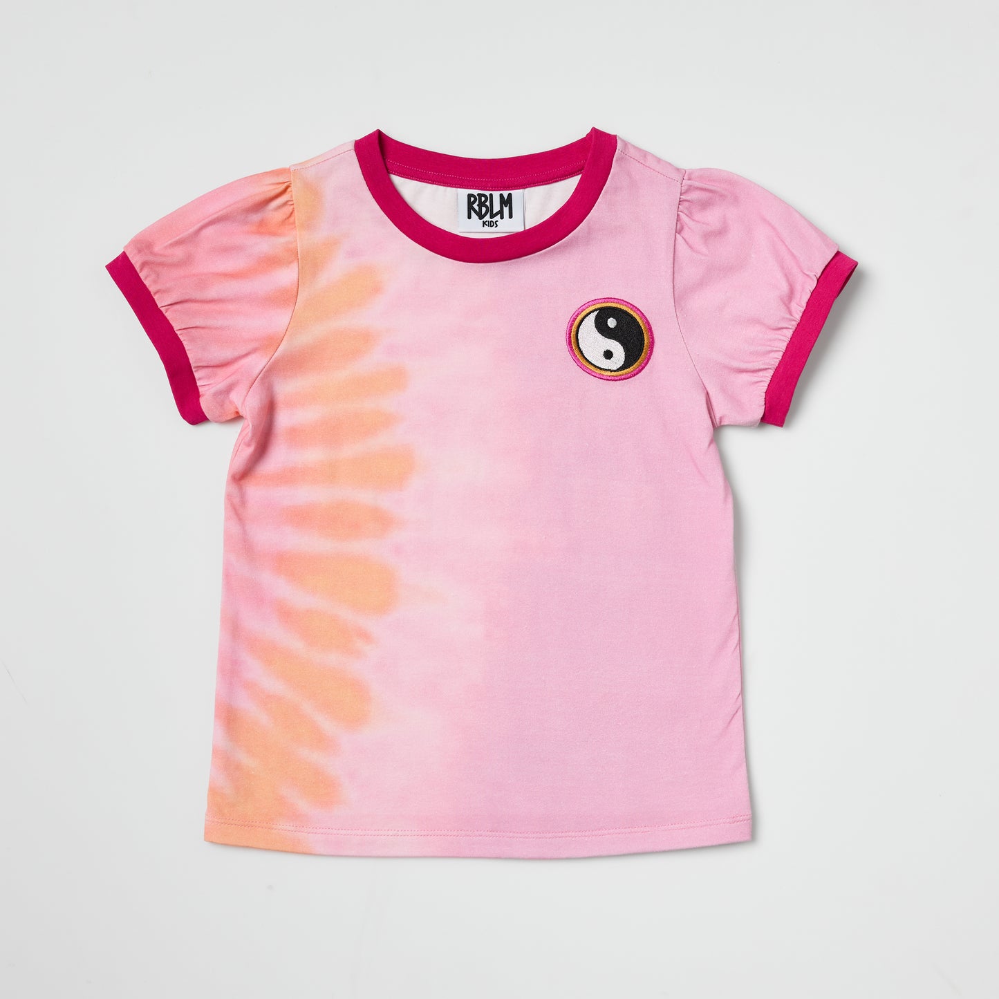 Sustainable kids pink tie-dye t-shirt with yin yang embroidery on a light gray background