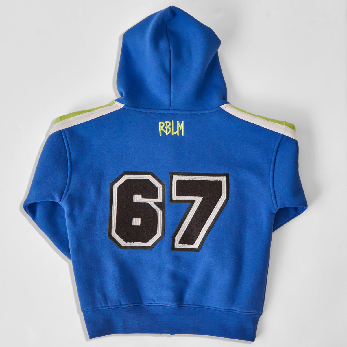 A sustainable and comfortable bright blue hoodie for children shown from the back, featuring the number 67 ("SIX SEVEN!") in black and white varsity lettering, and 'RBLM' printed in neon green near the neck. The hoodie has white and green stripes on the shoulders and is laid flat on a light gray background.