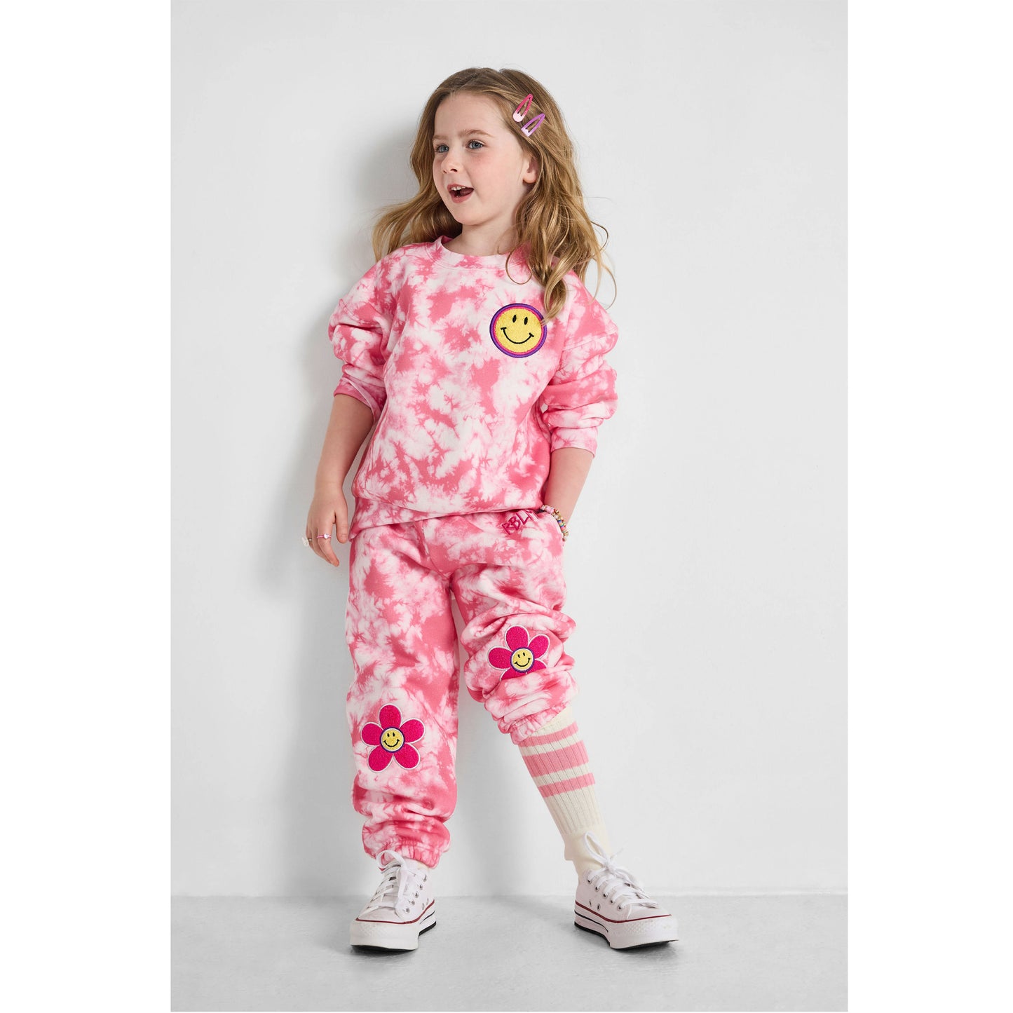 standing child wearing our sustainable Smiley Tie-Dye Set
